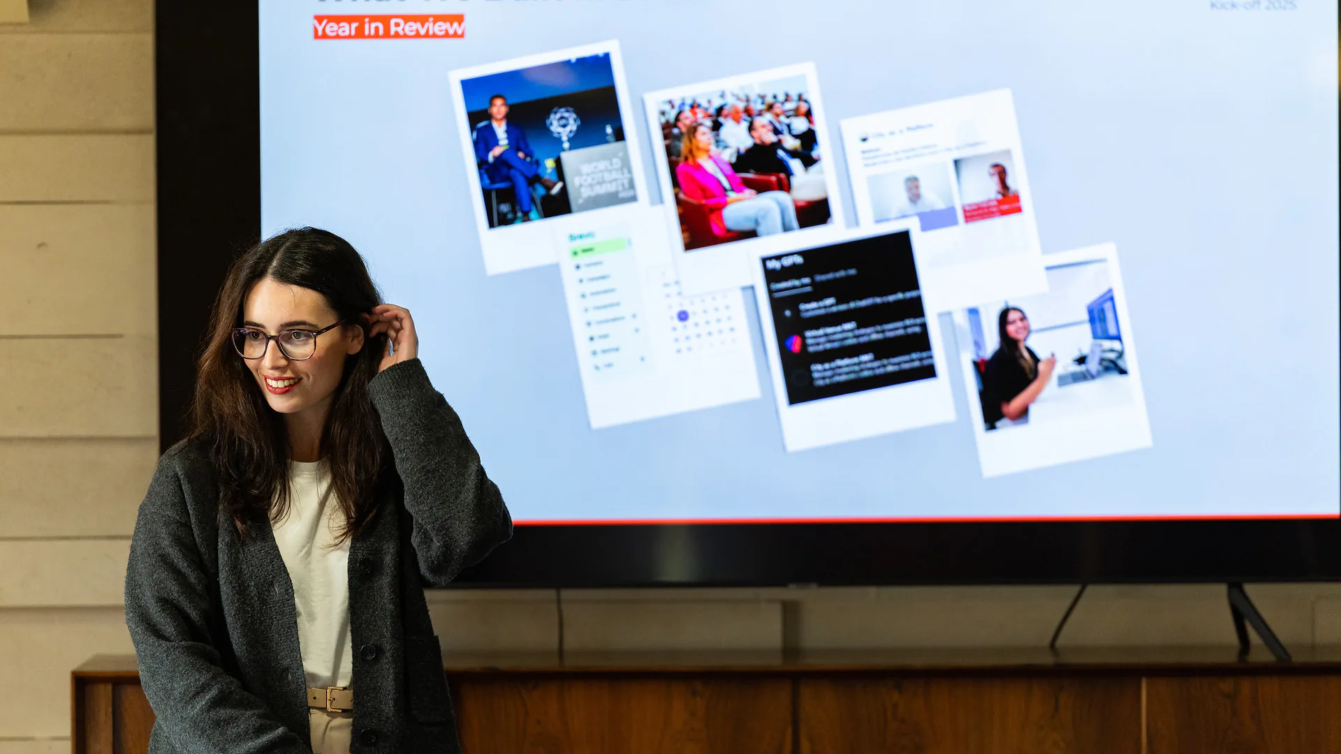 Scenic outdoor landscape with a green lawn, small pond with reeds, and trees under a partly cloudy sky.