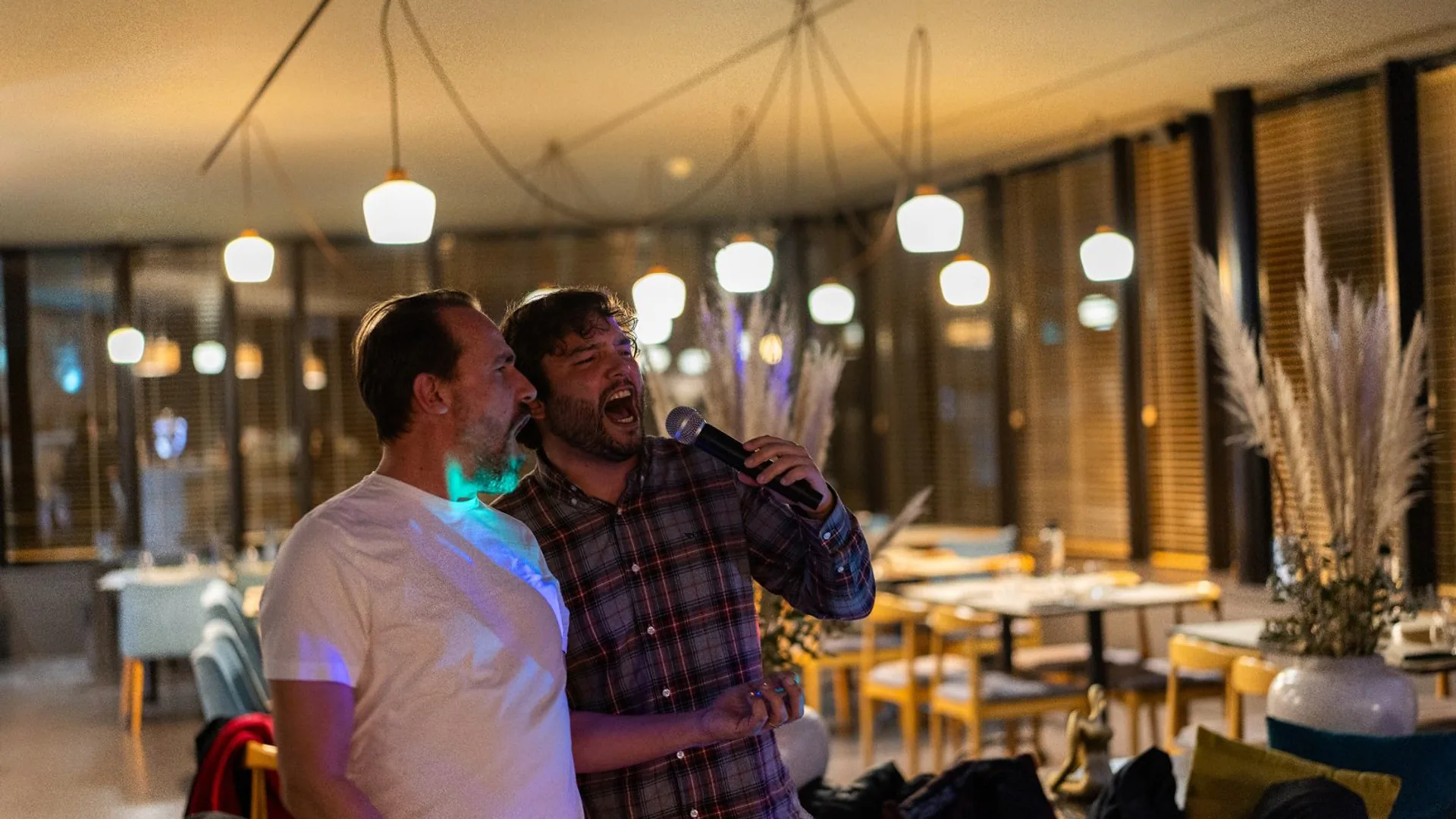 Woman presenting in front of a slide titled “What We Built in 2024,” adjusting her hair while standing beside the screen.